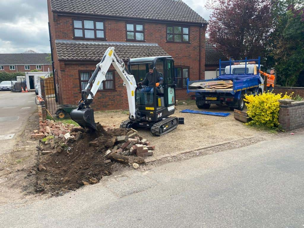 This is a photo of an operative of Newport Pagnell Driveways Digging out for a new tarmac driveway